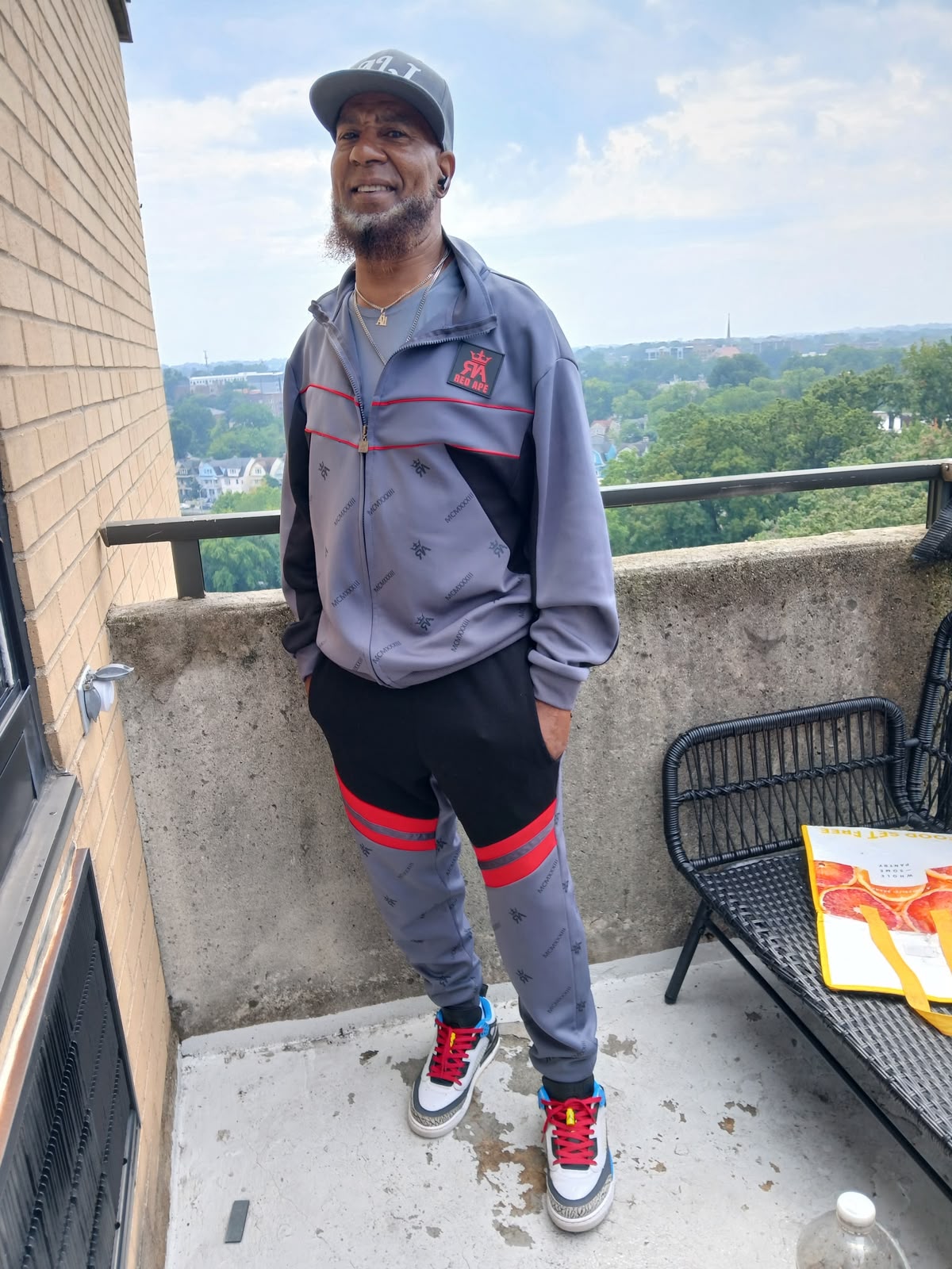 Abdur Ali standing on a balcony, smiling